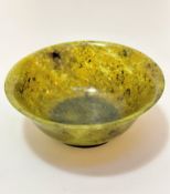 A Chinese spinach style jadeite bowl (7cm x 18cm)