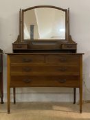 An Edwardian inlaid mahogany dressing table, the swing mirror over two trinket drawers and an open