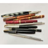 A collection of various fountain pens including a Parker, a presentation fountain pen to Arthur J