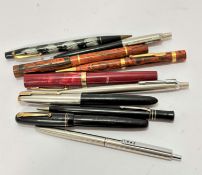 A collection of various fountain pens including a Parker, a presentation fountain pen to Arthur J