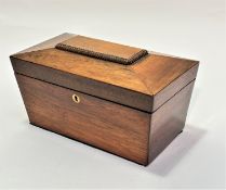 A 19thc rosewood sarcophagus shaped tea caddy, the top with fluted panel enclosing two tea