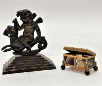 A 19th century Roman inspired cast brass desk paper weight of a winged cherub riding a ram with