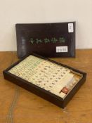 An early to mid 20th century Chinese resin mahjong set in a stained hardwood case, L27cm