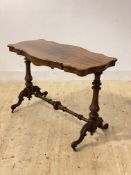 A Victorian rosewood stretcher table, the the serpentine top over shaped apron, raised on turned