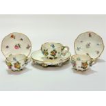 A pair of 19thc Meissen cabinet cups decorated with floral encrusted rose design with insects with