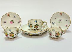 A pair of 19thc Meissen cabinet cups decorated with floral encrusted rose design with insects with