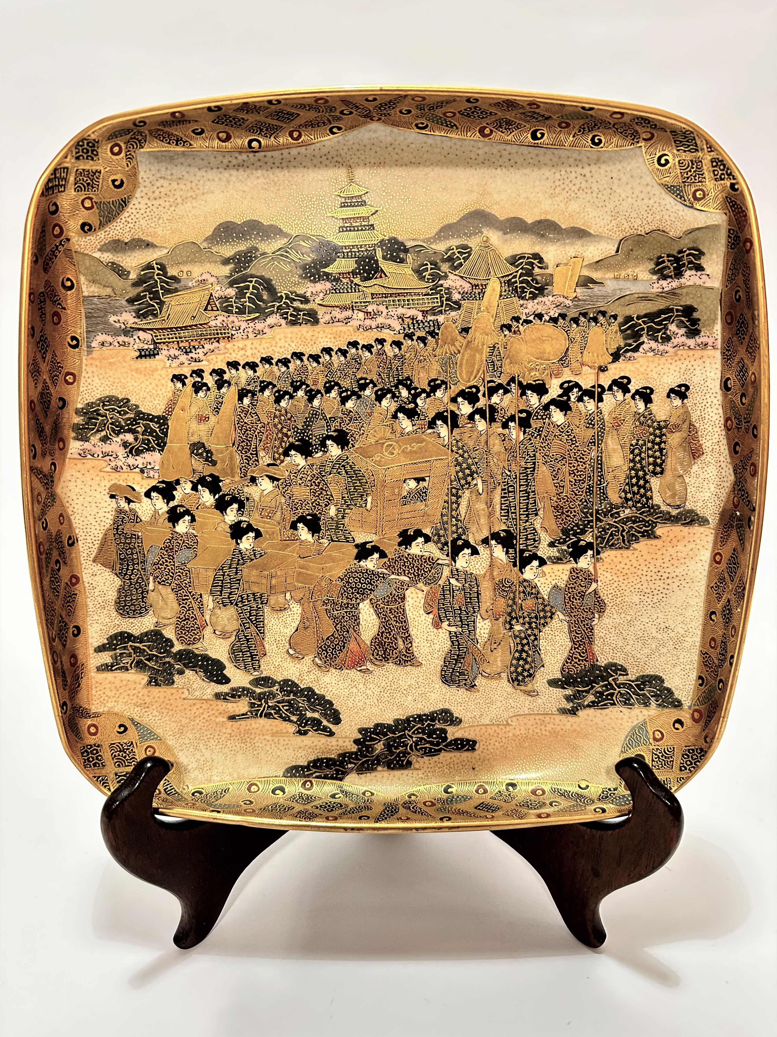 A Japanese Satsuma square shaped dish decorated with a procession of female courtiers with pagodas