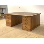 A large oak partners desk, early 20th century, the top inset with a gilt tooled skiver writing