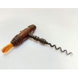A 19thc mahogany handled cork screw with bristle end, of turned barrel form with steel corkscrew, (