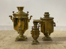A collection of three brass tea urns, largest H58cm
