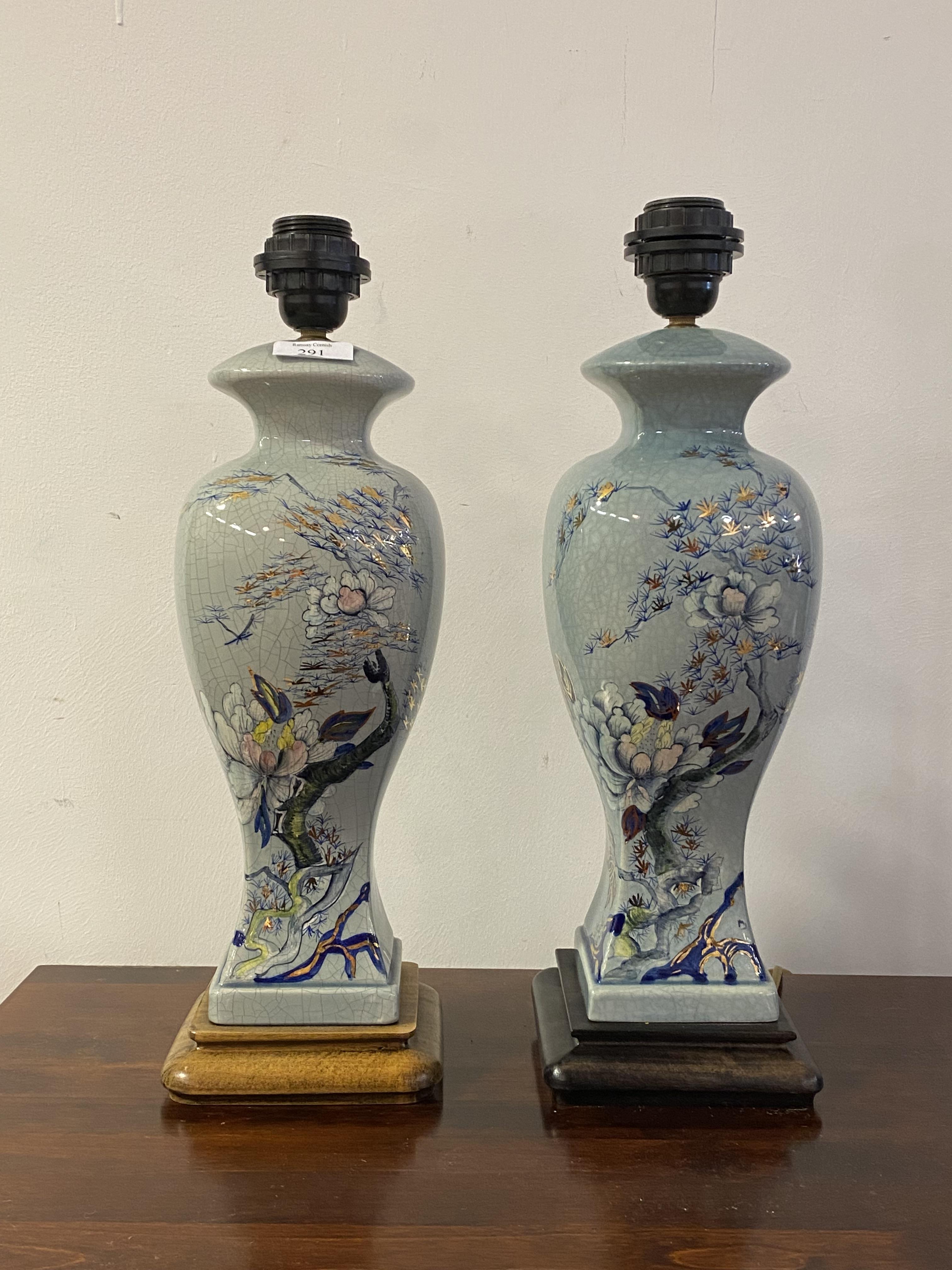 A pair of Chinese style crazed ceramic table lights of baluster vase form, each on a hardwood