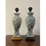 A pair of Chinese style crazed ceramic table lights of baluster vase form, each on a hardwood