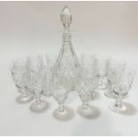 A crystal slice cut and thumb cut tapered decanter with faceted stopper, (h 34cm), slight chip to