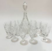 A crystal slice cut and thumb cut tapered decanter with faceted stopper, (h 34cm), slight chip to