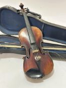 A late 19thc early 20thc satinwood two piece back four string violin, complete with chin rest, has