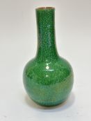 A late 19thc Chinese slim necked bottle style vase with green craquelure glaze, (h 20cm) no signs of