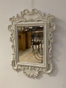 A French style wall mirror, the frame with scrolls enclosing a bevelled plate, 81cm x 60cm