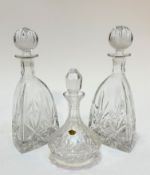 A pair of crystal slice cut triangular shaped decanters complete with ball stoppers, show no signs