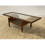 G-plan, A mid century teak coffee table, the inset plate glass top over an under tier and raised