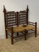 An Indian style turned twin chair, with woven string seat, (A/F) H108cm, W98cm, D53cm