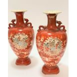 A pair of Japanese baluster form vases with dragon decorated handles to side and flared rims, with