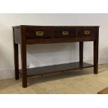 A hardwood and brass bound hall table, fitted with three drawers having recessed pull handles,