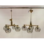 A pair of lacquered brass four branch ceiling light fittings, circa 1970's, each branch with a domed