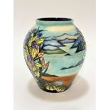 A modern Moorcroft baluster vase decorated with sea shells, sea urchins and lake in distance,