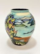 A modern Moorcroft baluster vase decorated with sea shells, sea urchins and lake in distance,