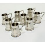 A set of eight English pewter baluster form tankards with C scroll handles to side, two slight dents