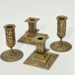 A pair of pierced column candlesticks with fleur de lis and leaf design with lift out drip trays