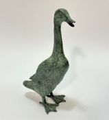 A patinated cast brass standing duck figure with verdigris style finish, (39cm x 20cm x 13.5cm),