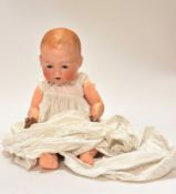 An Armand Marseille German baby bisque head doll model 351./8k with flirty eyes and open mount and