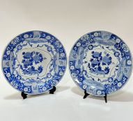 A pair of modern Chinese blue and white circular dishes the centre panel with Buddha lion and pup