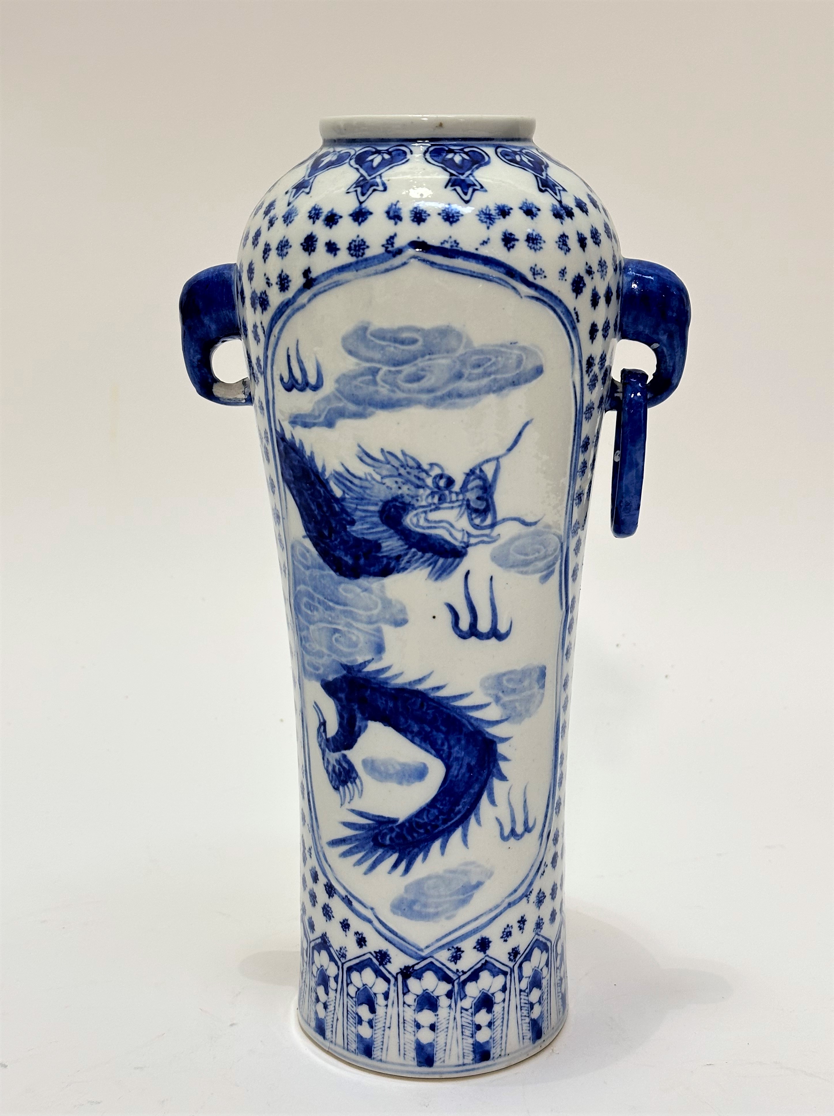 A Chinese porcelain blue and white decorated cylinder tapered vase decorated with relief dragon