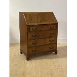 A Georgian style mahogany bureau, the cross banded fall front with tooled red leather writing