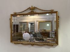 A gilt composition framed wall hanging mirror, in the neoclassical taste, late 20th century, the