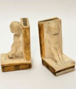 A pair of early 19thc plaster cast child figure book ends with decorated spines and leaves to books,