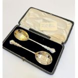 A pair of London silver gilt fruit spoons with panelled bowls complete with original presentation