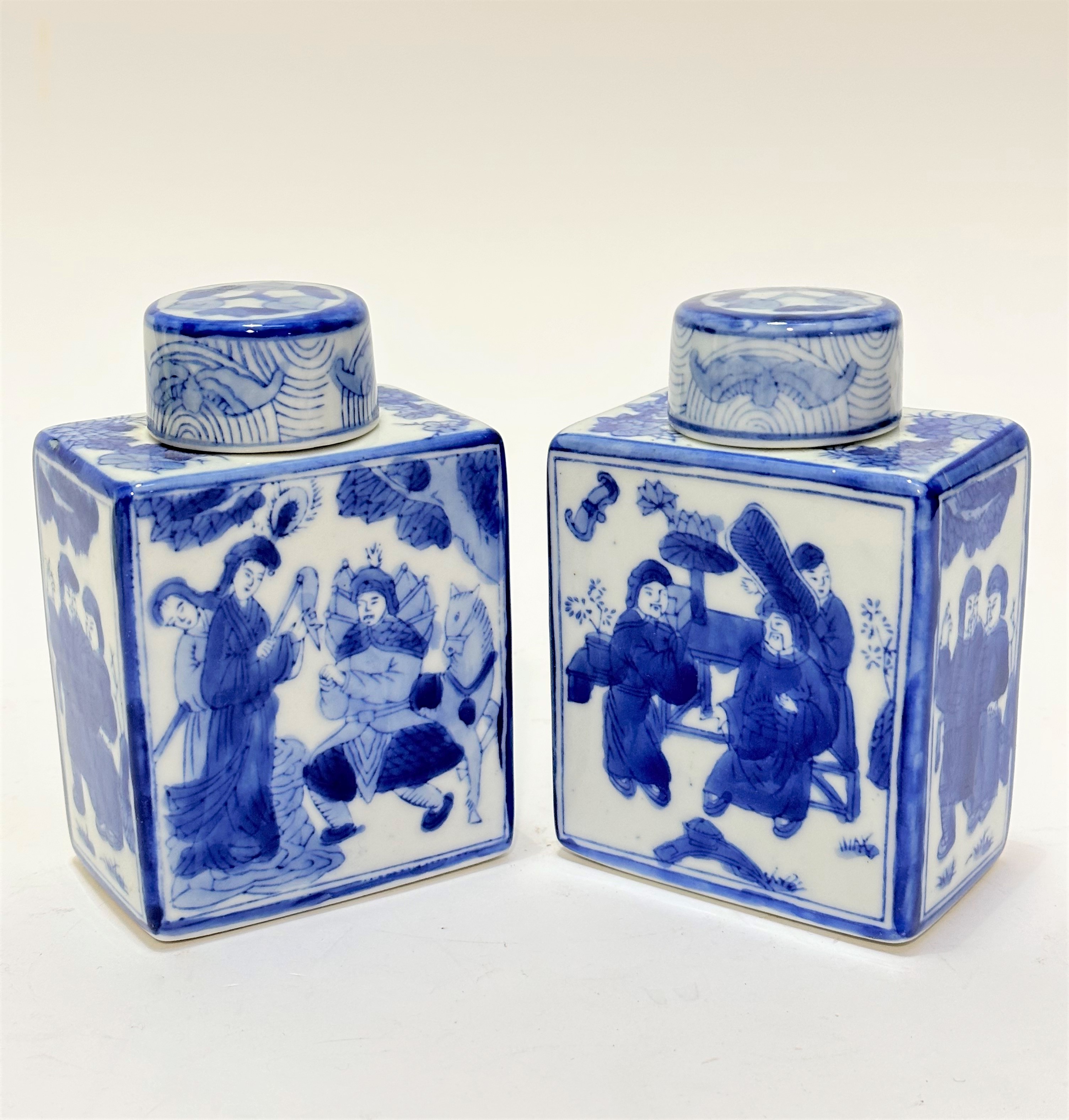 A pair of Chinese modern blue and white decorated square section tea caddys complete with covers,