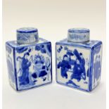 A pair of Chinese modern blue and white decorated square section tea caddys complete with covers,