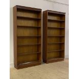 A pair of mid 20th century mahogany open bookcases, each with two fixed and three adjustable shelves