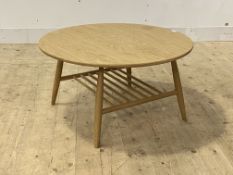 Ercol, a contemporary dry oak coffee table, the circular top raised on turned supports united by a