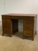 An early 20th century twin pedestal desk, the skivered top over frieze with three drawers, and two
