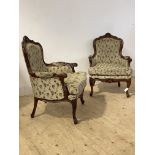 A Pair of French stye walnut framed bergere armchairs, the floral carved show frames enclosing