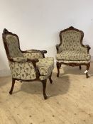 A Pair of French stye walnut framed bergere armchairs, the floral carved show frames enclosing