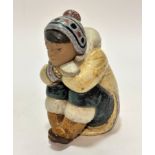 A Lladro Spanish pottery figure, Pensive Eskimo Boy, (18cm x 9cm x 13cm)