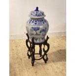 A large Chinese blue and white ceramic baluster urn and cover, painted with chrysanthemum, figures
