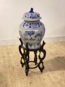A large Chinese blue and white ceramic baluster urn and cover, painted with chrysanthemum, figures