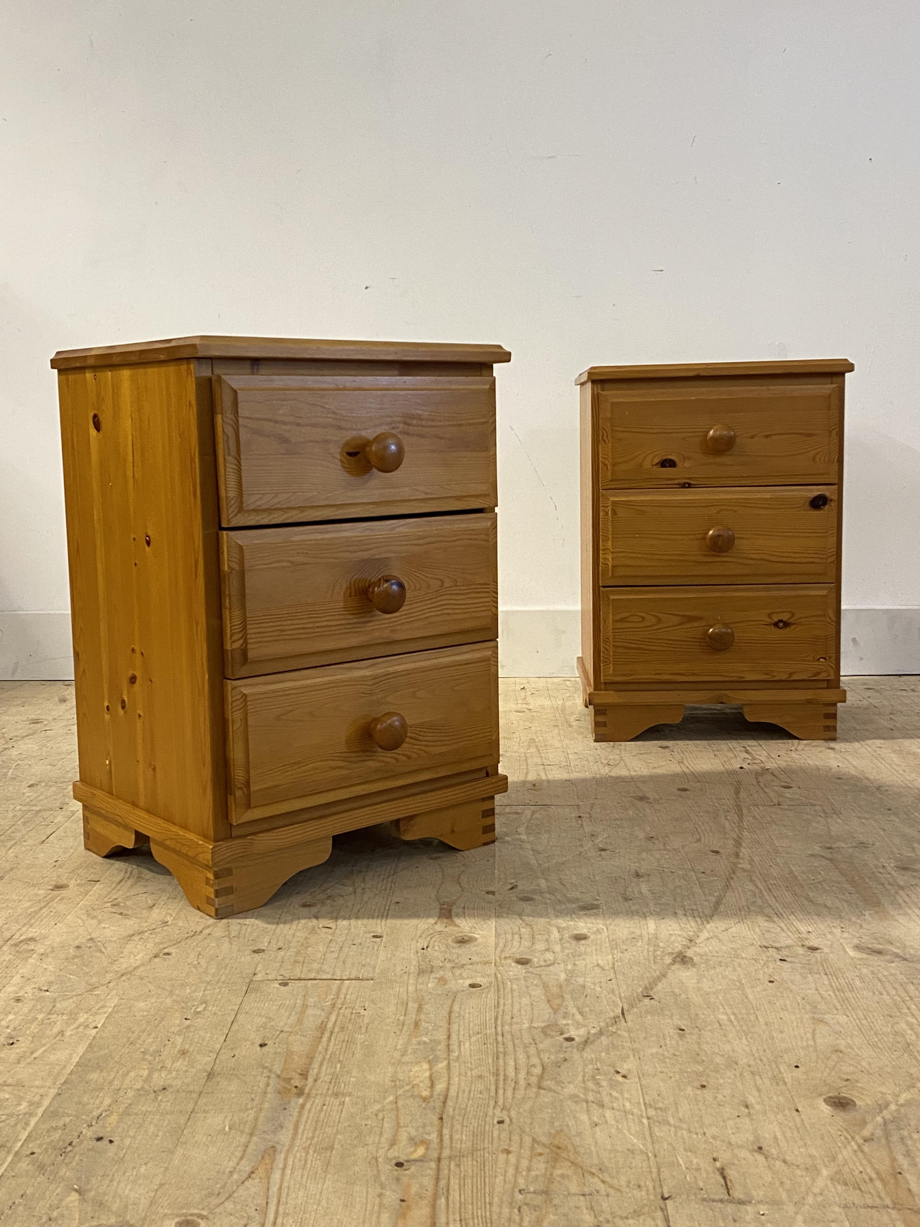 A pair of polished pine three drawer bedside chests, H61cm, W41cm, D36cm